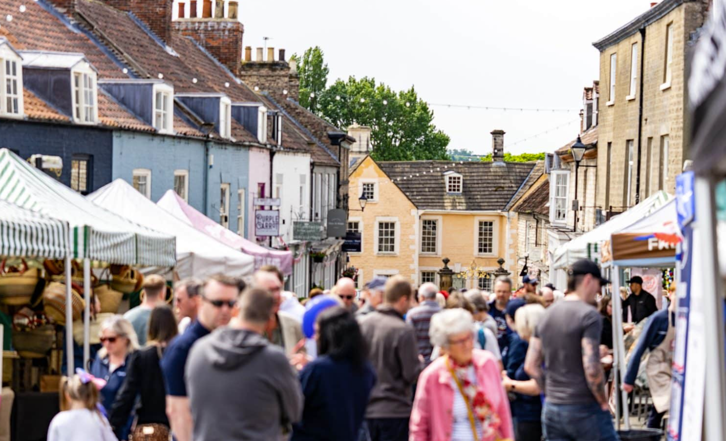 Market stalls and visitors in Malton town centre