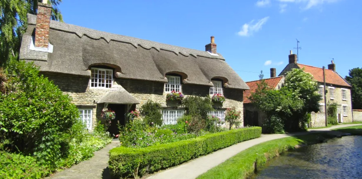 The thatched Beck Isle cottage beside the clear beck running through the village of Thornton-le-Dale