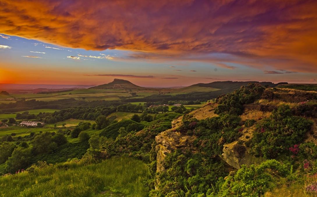 Roseberry Topping and the countryside above Great Ayton beneath a fiery sunset sky